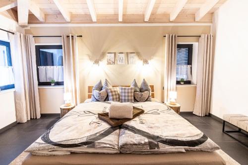 a bedroom with a large bed in a room with windows at Riedbach-Lodge 3 in Viechtach