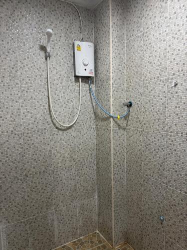 a shower in a bathroom with a shower at WannaB Hostel in Khlong San