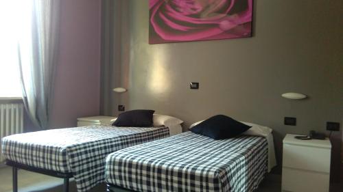 Ένα ή περισσότερα κρεβάτια σε δωμάτιο στο La Quercia Hotel con Ristorante