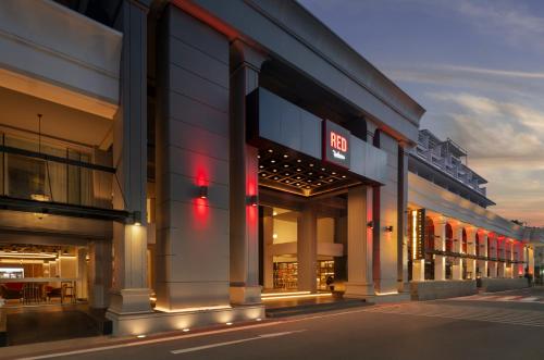 a group of buildings with lights on them at Radisson RED Phuket Patong Beach in Patong Beach