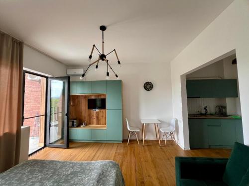 a room with a bed and a kitchen with a table at Bazaleti Heaven in Bazalet'i
