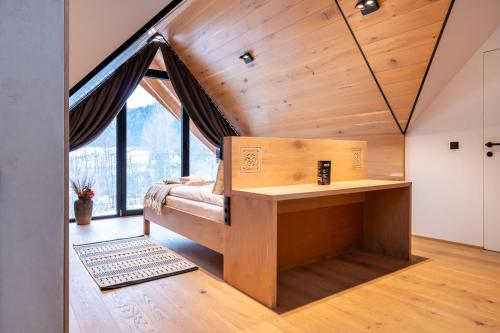a bedroom with a bed in a room with a window at Zacisze Gór by Apart Concept Podhale in Zakopane