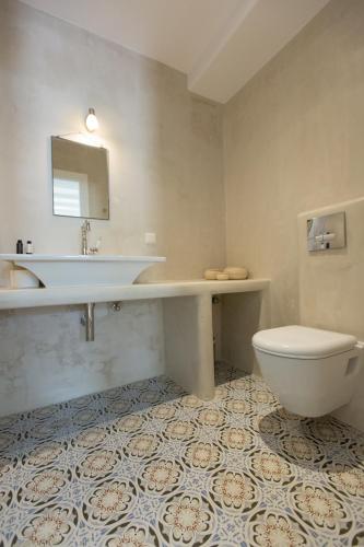 a bathroom with a sink and a toilet at Nastasia Village in Naxos Chora