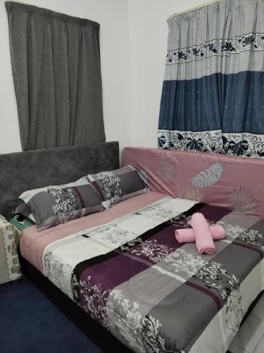 En eller flere senge i et værelse på Rezquna Homestay