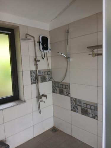 a shower in a bathroom with a window at OCEAN DREAM-Beach House in Phú Quốc