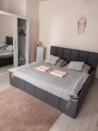 a large bed in a white room with a large bed at Apartmán 6- Self check-in in Spišské Podhradie
