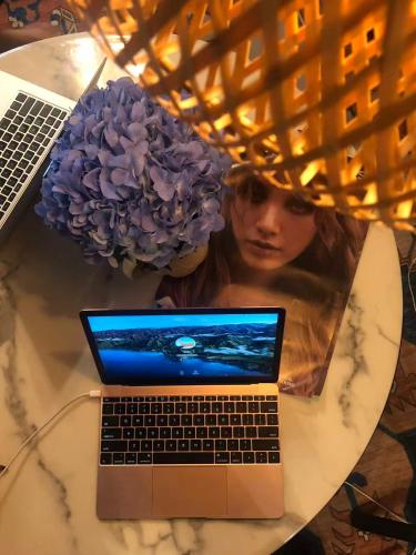 a laptop computer sitting on top of a table at WSTAR Hostel in Bangkok