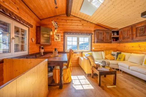 a living room with a couch and a table at Chalet Mazze in Bettmeralp