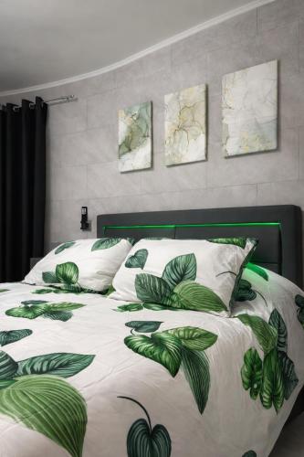 a bedroom with a bed with green leaves on it at Il Rifugio Nel Vicolo in Subiaco