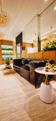 a living room with a couch and a table at Apartamento perto da Praia em Itapema!!! in Itapema