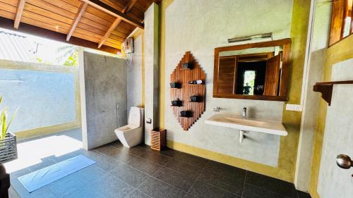 a bathroom with a sink and a mirror at Ceylon Elegance Villa in Kurunegala