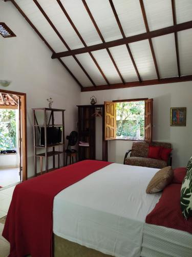 a bedroom with a large bed and a couch at Campo das Margaridas Santo Andre in Santo André