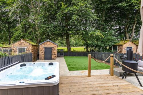 a hot tub on a wooden deck with a backyard at Yarrow cottage in Broadmeadows