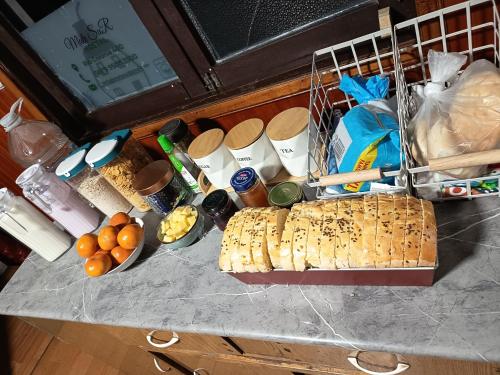 a counter top with bread and other food on it at Mate Sur Hostal in Cochrane