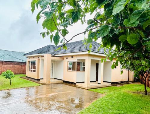 a house in the rain with at Asamez Apartments in Lilongwe