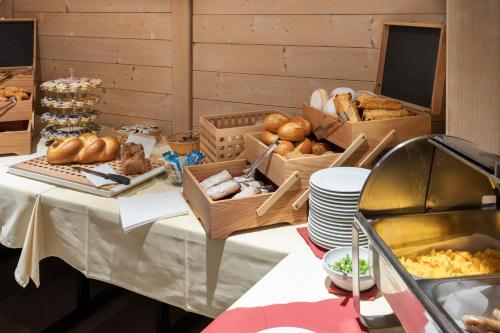 a table topped with boxes of bread and other foods at Hotel Grindelwalderhof in Grindelwald