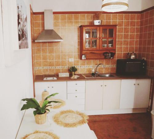 a kitchen with a sink and a counter top at Casa Olga in Caleta de Sebo