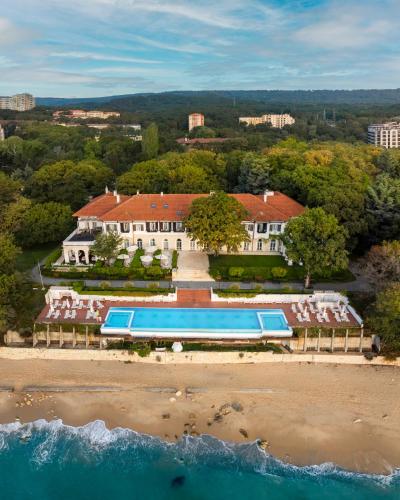an aerial view of a house with a swimming pool on the beach at HVD Boutique Hotel Oasis - Private Beach & Free Parking in Golden Sands