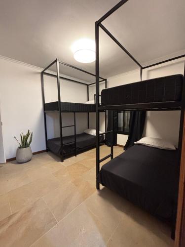 two bunk beds in a room with a ceiling at Beach House AP in Miramar