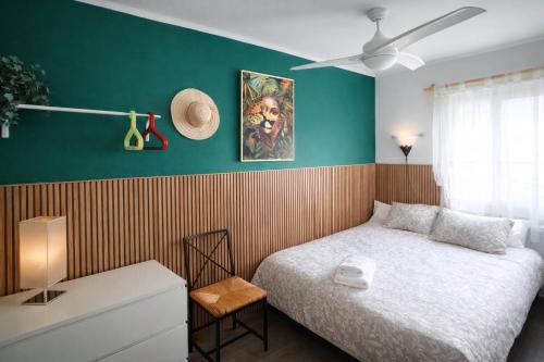 een slaapkamer met een bed en een groene muur bij Bianca Seaview & Beach Apartment in Montgat