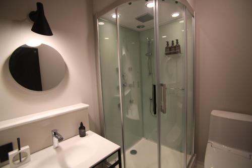 a bathroom with a glass shower and a sink at TAP Inn MIURA in Miura