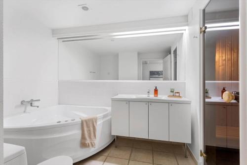 a white bathroom with a tub and a sink at LL264-Bagenkop-Faergevej-9-1-th in Bagenkop