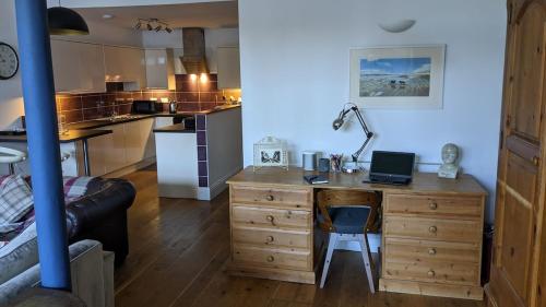 a room with a desk with a laptop on it at St Davids House in Cranbrook