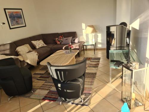a living room with a couch and a table at Sonnenhus 1 - BreegeRügen in Breege