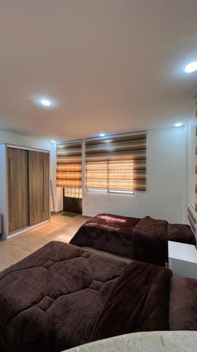 a large bedroom with two beds and a window at شقة مفروشة apartment amman alnuzzha in Amman