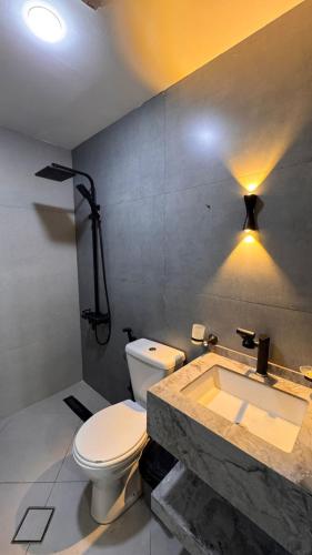 a bathroom with a toilet and a sink at شقة مفروشة apartment amman alnuzzha in Amman