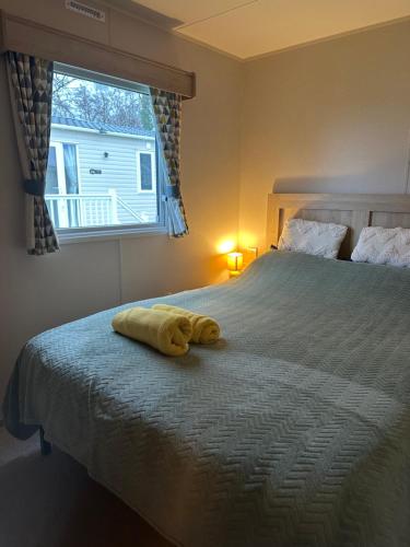 a yellow towel laying on a bed in a bedroom at Horizon Bay in Longniddry