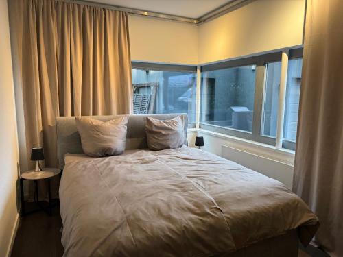 a bedroom with a bed with a large window at Wellness Oase in Paderborn