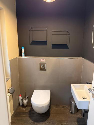 a bathroom with a white toilet and a sink at Wellness Oase in Paderborn