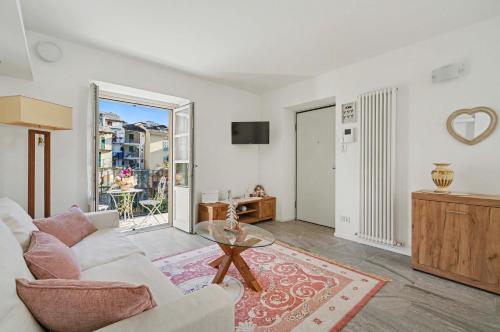 a living room with a white couch and a table at Apartment Maira in Chiavenna