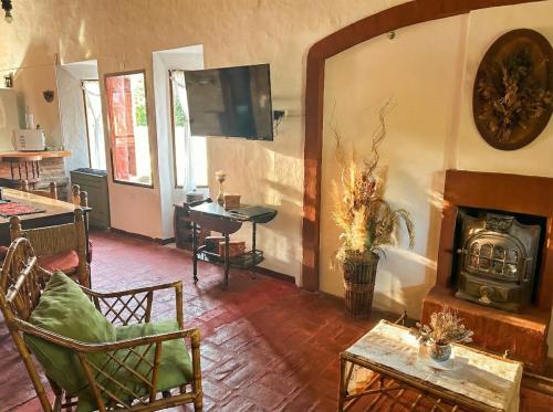 un salon avec une cheminée et une télévision dans l'établissement Casa Quinta Chascomús, à Chascomús