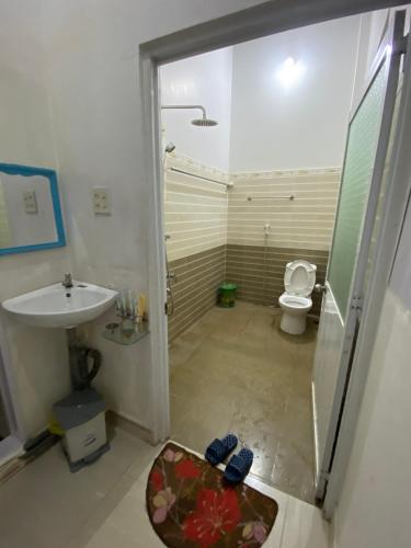 a bathroom with a shower and a sink and a toilet at Hotel Sơn Duyên in Ấp Thiện Lập