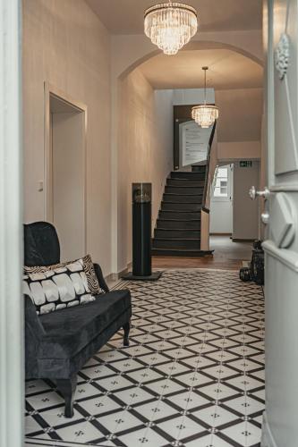 a living room with a couch and a staircase at Kremers Freiräume in Arnsberg