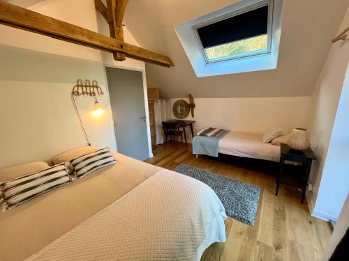 a small bedroom with a bed and a window at Bruisse in Les Iffs