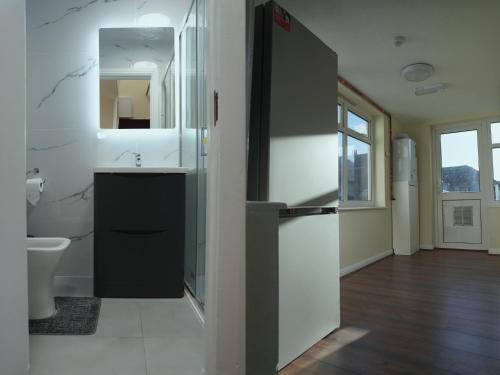 a bathroom with a sink and a mirror at SS Sunrise & Silk in Bognor Regis