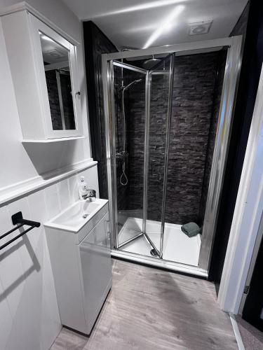a bathroom with a shower and a sink at Jasper Apartment in Lyme Regis