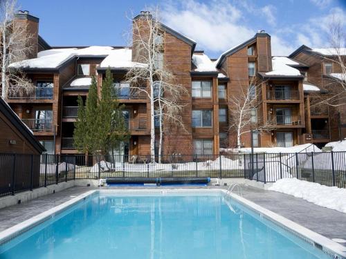 a swimming pool in front of a building at Hot tubs and pool -Looping shuttle- Cozy fireplace in Steamboat Springs