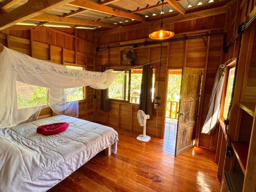 a bedroom with a bed in a wooden room at Koh Mook Banana Garden in Ko Libong
