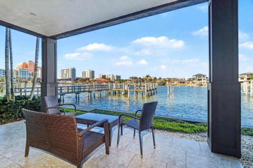 a patio with a table and chairs and a view of the water at BrightWater Blue 158-2 in Clearwater Beach