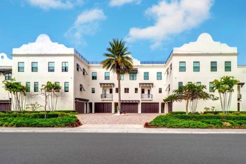 a large white building with palm trees in front of it at BrightWater Blue 158-2 in Clearwater Beach
