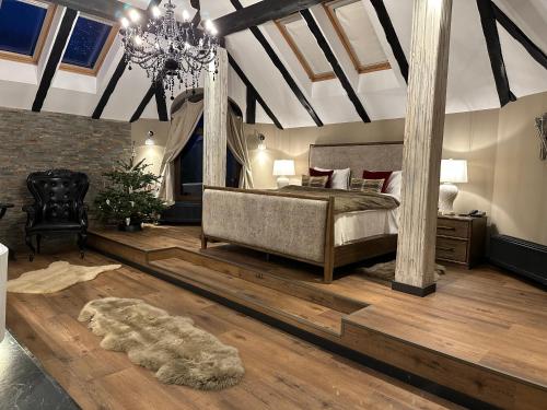 a bedroom with a bed and a chandelier at Relax in Style Boutique Hotel in Braşov