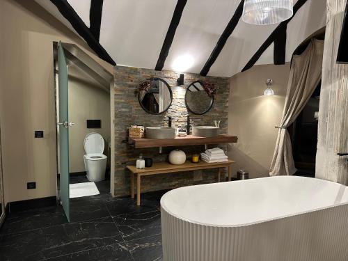 a bathroom with a bath tub and a toilet at Relax in Style Boutique Hotel in Braşov