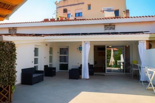an outdoor patio with chairs and a building at Tortolì Old Town in Tortolì