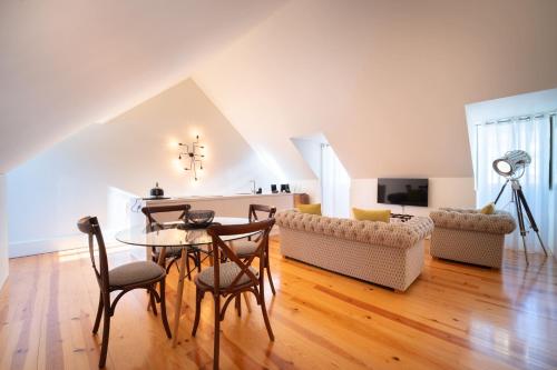 a living room with a table and chairs and a couch at Once Upon Lisboa in Lisbon