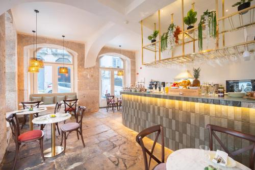 a restaurant with tables and chairs and a bar at Once Upon Lisboa in Lisbon