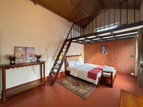 a bedroom with a loft bed and a ladder at Burnside Cottage in Kotagiri